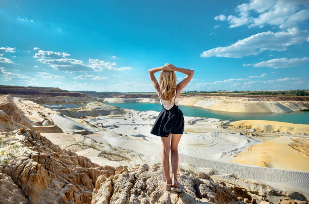 Girl on the background of quartz sand quarry stock photo