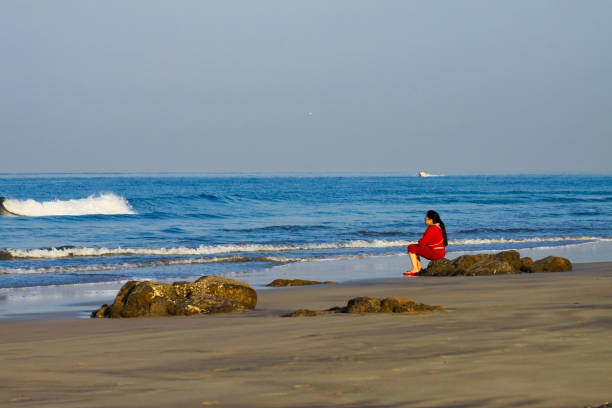 Girl relaxing in Goa Beach in morning stock photo