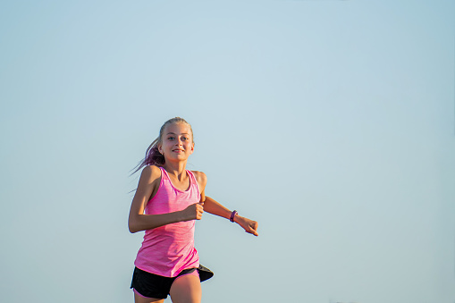 Girl runs on a sunny summer evening