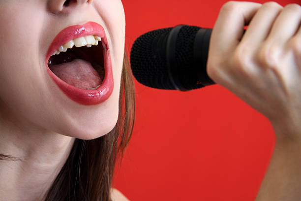 girl sings in  microphone. stock photo
