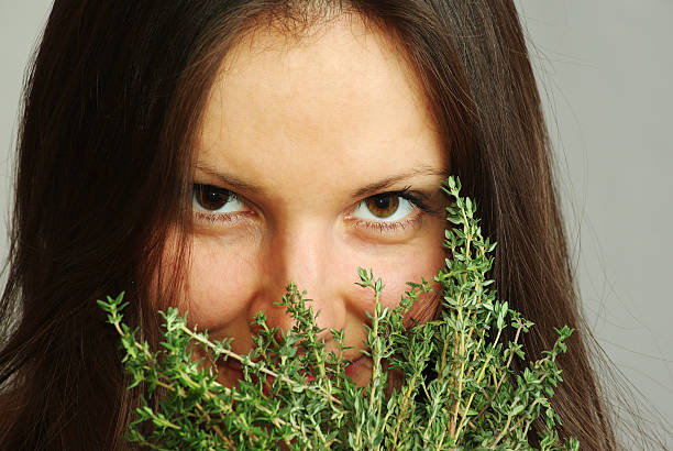 Girl sniffing thyme stock photo