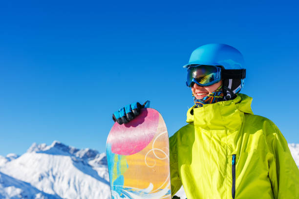Girl snowboarder having fun in the winter ski resort. stock photo