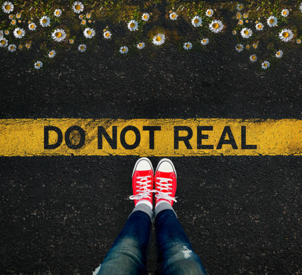 Girl standing in front of the DO NOT REAL sign and a well that scares stock photo