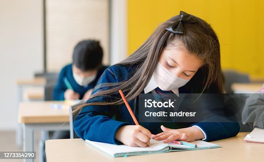 istock Girl studying at the school wearing a facemask during the pandemic 1273354290