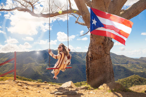 Girl Swinging Puerto Rico Happy girl swinging from tree over mountain landscape at Curva Del Arbol in Cayey Puerto Rico puerto rican women stock pictures, royalty-free photos & images