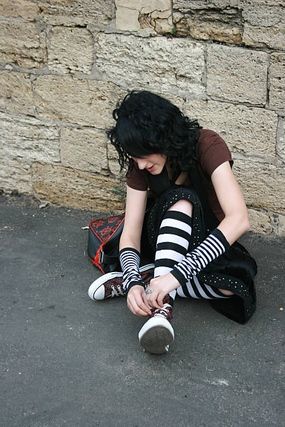 Girl tie up her laces stock photo