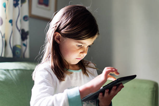 Girl using tablet computer stock photo