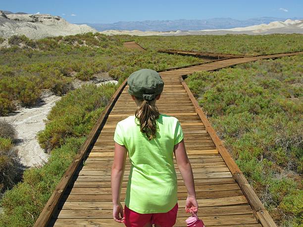 Girl Walking, Salt Creek Trail, Death Valley National Park, California stock photo