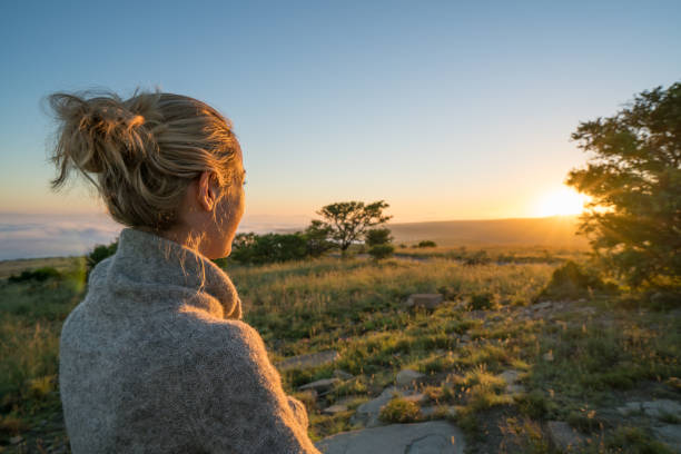 Girl watching sunrise in South Africa stock photo