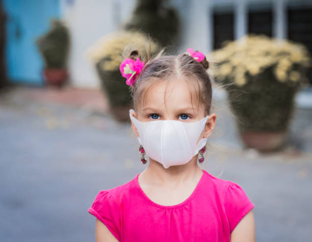 Girl wearing facial disposable mask. Virus protection stock photo