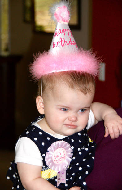 Girl with a funny face at her birthday party stock photo
