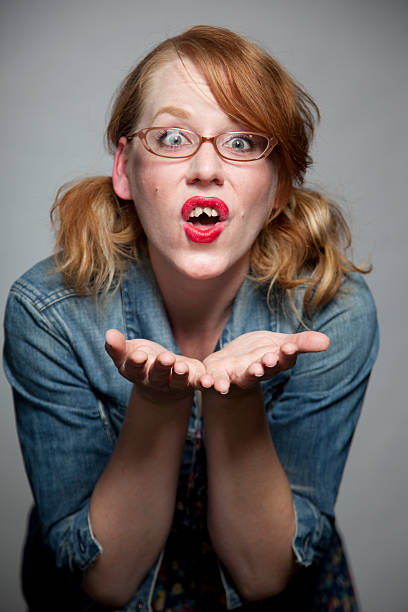 Girl with bad teeth blows a kiss A girl with bad teeth blows a kiss to the camera. ugly girl stock pictures, royalty-free photos & images