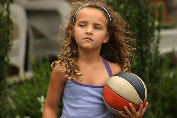 girl with curls and basketball stock photo