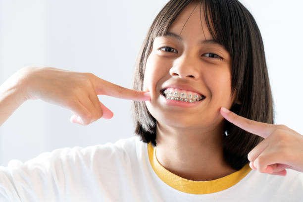Girl with dental braces smiling and happy stock photo