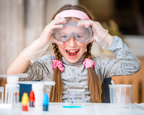 girl with flasks for chemistry stock photo