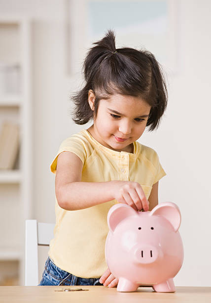 Girl With Piggy Bank stock photo
