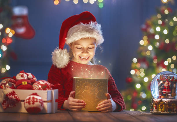 girl with present - christmas magic imagens e fotografias de stock