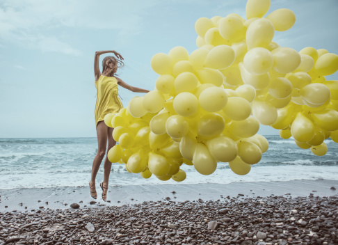 girl with yellow balloons