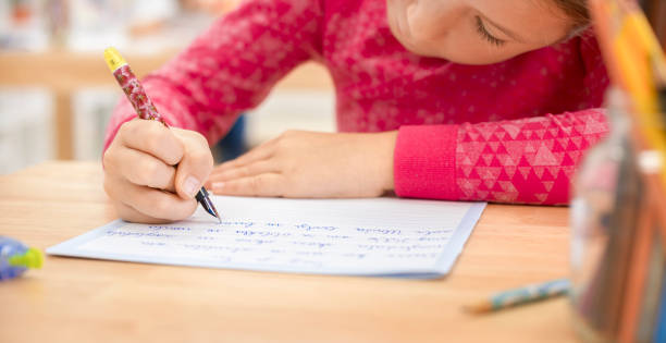 Girl writing in notebook stock photo