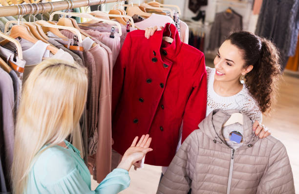 Girlfriends choosing warm jacket stock photo