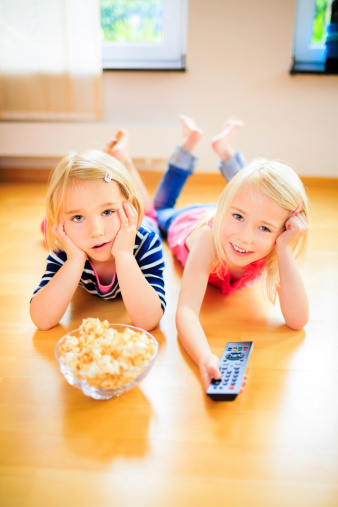 Girls Glued To The Television Stock Photo - Download Image Now - iStock