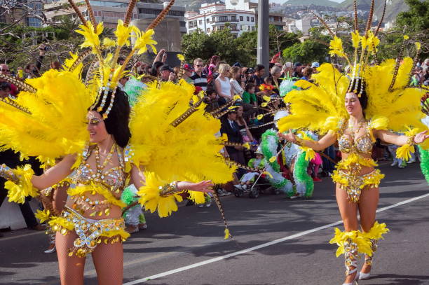 girls in yellow feather suits dance in front of the audience. - cargo canarias imagens e fotografias de stock