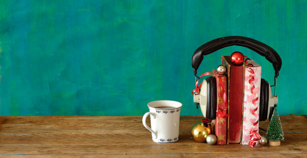 Giving audio books for christmas with christmas decoration, vintage headphones and cup of coffee.Gift,present,christian holiday concept, copy space. stock photo