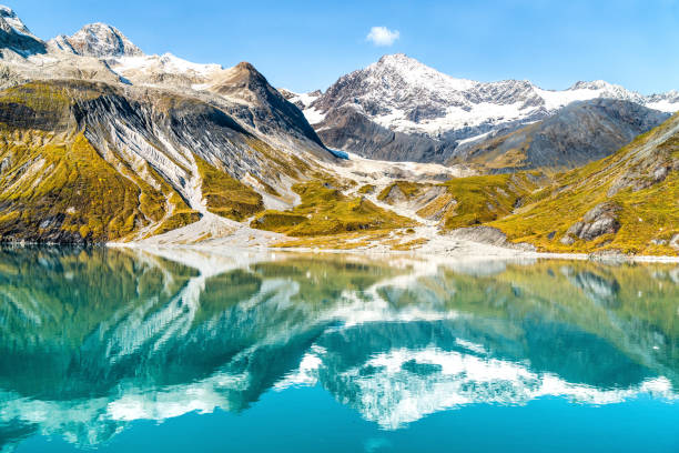 Glacier Bay National Park Alaska USA Glacier Bay National Park, Alaska, USA. Amazing glacial landscape showing mountain peaks and glaciers on clear blue sky summer day. Mirror reflection of mountains in still glacial waters. alaska stock pictures, royalty-free photos & images