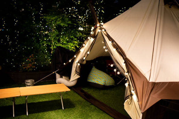 Glamping tent with decoration fairy lights at night time stock photo