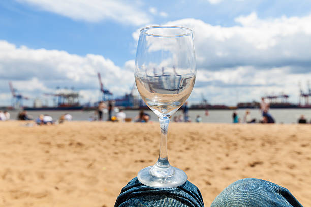 Glas of wine at the River Elbe Balancing a glas of wine in Oevelgönne, Hamburg elbe river stock pictures, royalty-free photos & images