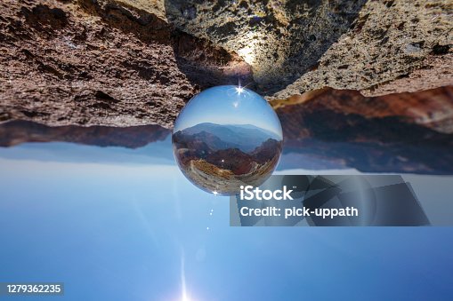 istock Glass ball reflection of landscape 1279362235