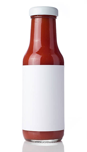 Glass bottle of tomato ketchup with a blank label Tomato Ketchup bottle with a blank label isolated on a white background. Ideal for imposing your own artwork onto. sauce stock pictures, royalty-free photos & images