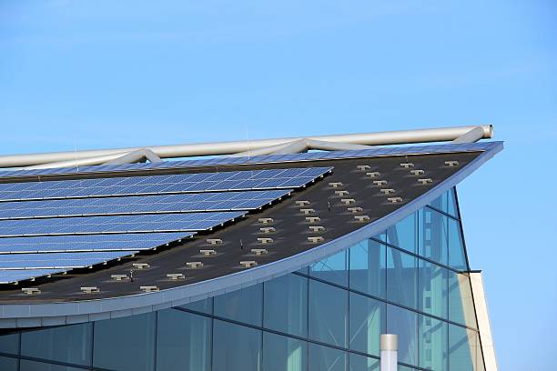 Glass building with solar panels on the roof stock photo