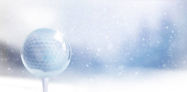 Glass Christmas ball with golf ball against blurred blue background with snowflakes stock photo
