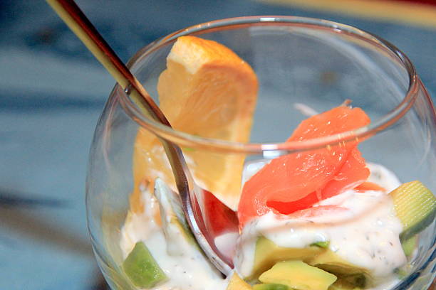 Glass cup with avocado and salmon stock photo