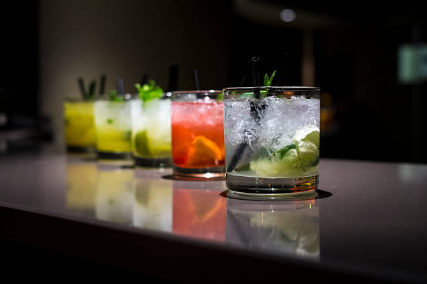 Glass cups filled with different flavored mojitos Several flavored mojitos on a bar. vodka drinks stock pictures, royalty-free photos & images