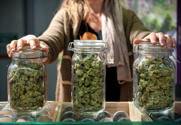 Glass jar full of Cannabis Sativa Glass jar full of Cannabis Sativa for sale at a market stall. bud stock pictures, royalty-free photos & images