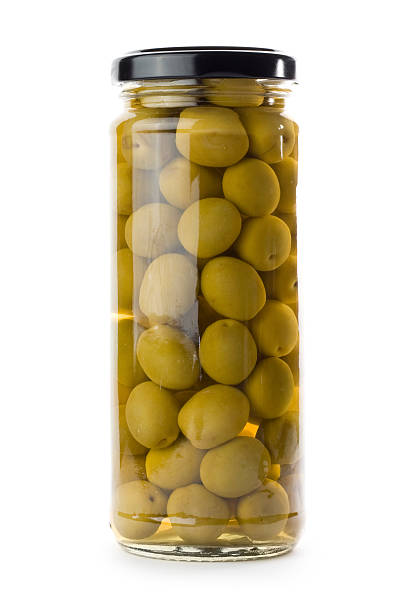 Glass jar of green olives isolated on a white background A Jar of olives isolated on a white background. green olives jar stock pictures, royalty-free photos & images