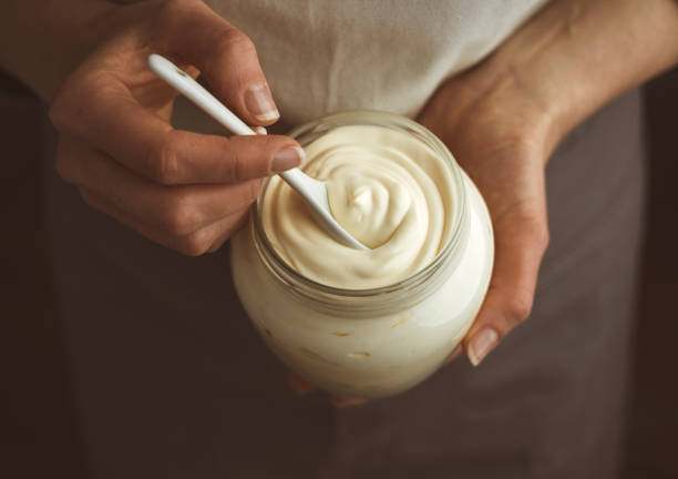 Glass jar of mayonnaise with a spoon. stock photo