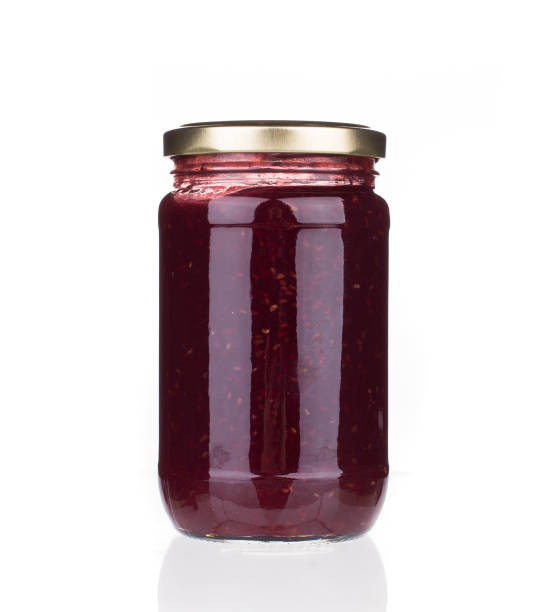 Glass jar with berry jam. Glass jar with berry jam. Isolated in a white background. Close-up. marmalade stock pictures, royalty-free photos & images