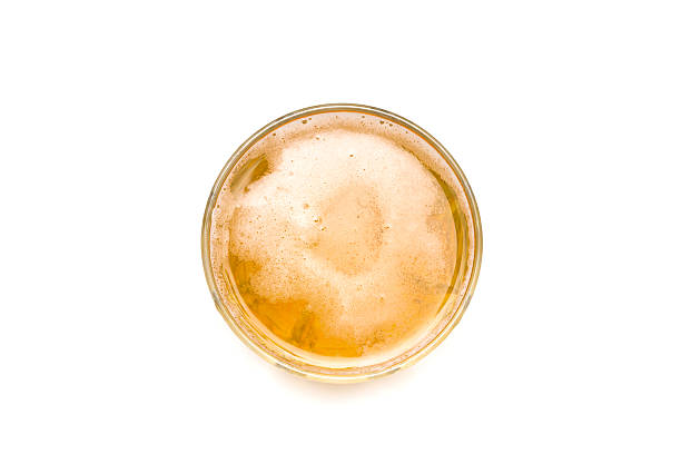 glass of beer, isolated on white background, directly above view. stock photo