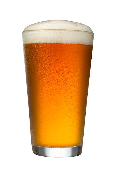 Glass of Beer on White Background A glass of beer with froth head on a white background with clipping path.  Please see my portfolio for other food and drink images.  pint glass stock pictures, royalty-free photos & images