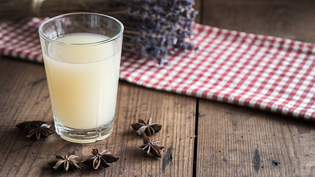Glass of French Pastis on a wooden table Glass of Pastis anise stock pictures, royalty-free photos & images