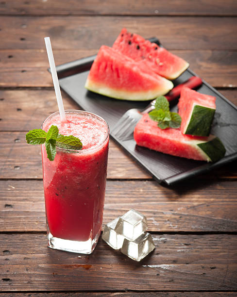 glass of fresh watermelon juice on wood glass of fresh watermelon juice isolated on white watermelon juice stock pictures, royalty-free photos & images