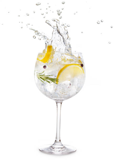 glass of gin tonic splashing gin tonic splashing isolated on white background gin stock pictures, royalty-free photos & images