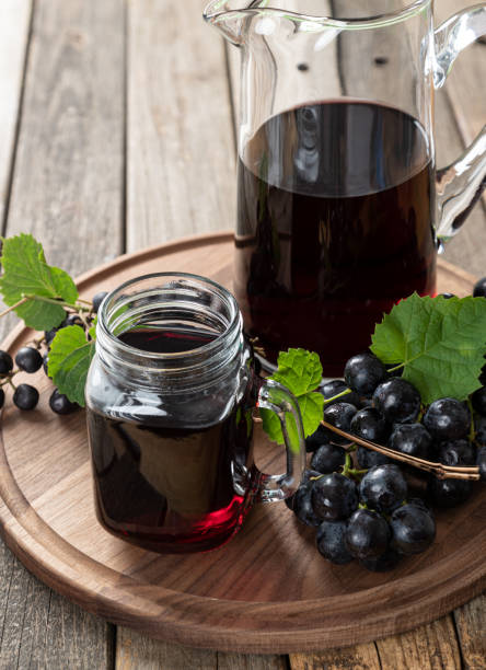 Glass of Grape Juice and Fresh Grapes stock photo