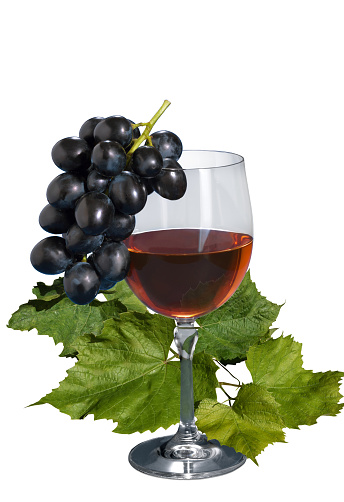 A glass of grape wine with grape leaves on an isolated white background.