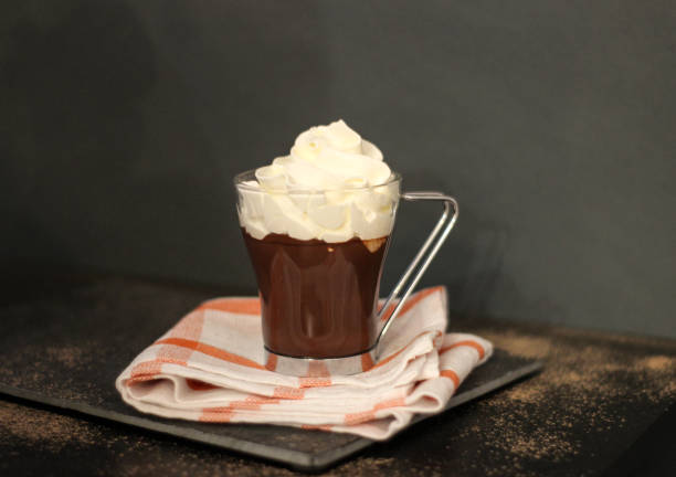 Glass of hot chocolate Glass of hot chocolate with whipped cream on dark background semi sweet chocolate stock pictures, royalty-free photos & images