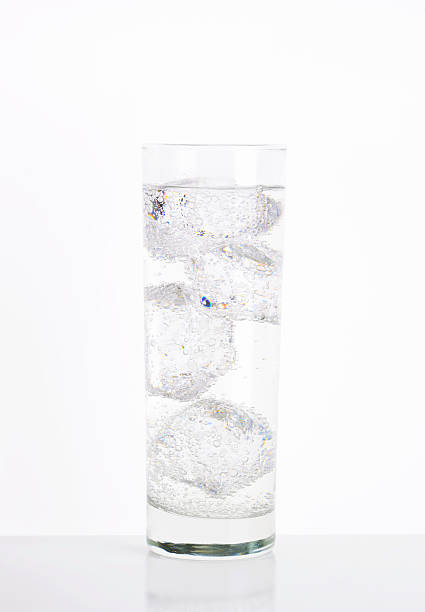 Glass of ice fizzy water Glass of sparkling water with ice highball glass stock pictures, royalty-free photos & images