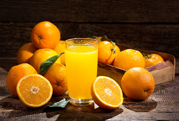 glass of orange juice with fresh fruits stock photo